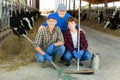 Milk farm workers in cowhouse Royalty Free Stock Photo