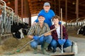 Milk farm workers in cowhouse Royalty Free Stock Photo