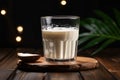 Milk filled glass glistens, tempting on the wooden tabletop