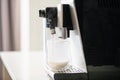 Milk flow from coffee machine to glass Royalty Free Stock Photo