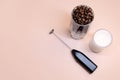 Milk foam maker with glass of milk on pink peach background Royalty Free Stock Photo
