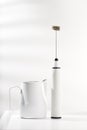 Milk frother and white pitcher Royalty Free Stock Photo