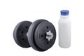 Milk in a glass and Big black dumbells ,over white background Royalty Free Stock Photo