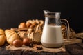 Milk in a glass bottle placed on a wooden table with ingredients