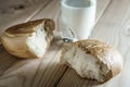 Milk in a glass. Bread on wooden background. Bio products. Food.