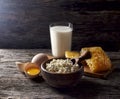 Milk in glass, honeycomb and eggs on a wooden background. Cottage cheese in a wooden bowl, rustic style. Dairy products in the mo Royalty Free Stock Photo