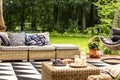 Milk and grapes on a table, sofa with knot pillow and geometrical carpet on a terrace in spa