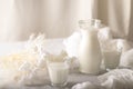 Milk in a jug and glasses on a white background. Tablecloth. Flowers . copy space Royalty Free Stock Photo