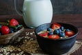 Milk in a jug and oatmeal porridge with fresh ripe berries Royalty Free Stock Photo