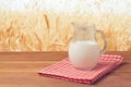 Milk Jug Over Wheat Field Background