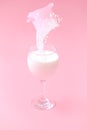 milk with oatmeal is poured into a glass. pink background. Royalty Free Stock Photo