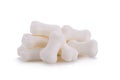 Milk pellet in the shape of a bone on white background. Royalty Free Stock Photo