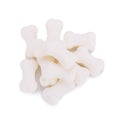 Milk pellet in the shape of a bone on white background. Royalty Free Stock Photo