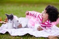 Milk, picnic and a girl in the park with her kitten together for love, care or bonding during summer. Smile, cat or kids Royalty Free Stock Photo