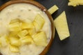 milk pineapple yogurt with pieces of pineapple and other fruits