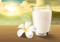 Milk and plumeria on wooden table on the morning