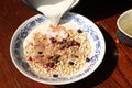 Milk pouring into bowl of cereals Royalty Free Stock Photo