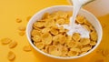 Milk pouring into bowl of corn flakes Royalty Free Stock Photo