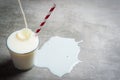 Milk pouring into glass on a concrete table Royalty Free Stock Photo