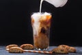 Milk pouring into glass of iced coffee Royalty Free Stock Photo