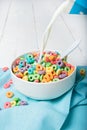 Milk pouring into plate with Colorful cereal Royalty Free Stock Photo