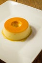 Milk Pudding or Pudim de leite. Brazilian dessert homemade caramel custard pudding. Traditional brazilian flan on wooden