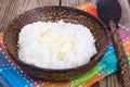 Milk rice porridge with butter in wooden bowl Royalty Free Stock Photo