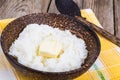 Milk rice porridge with butter in wooden bowl Royalty Free Stock Photo