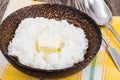 Milk rice porridge with butter in wooden bowl Royalty Free Stock Photo