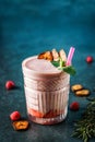 Milk smoothie strawberry, banana, raspberries in glass on dark blue background. Summer cold drink and healthy breakfast Royalty Free Stock Photo