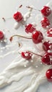 Milk splash surrounds fresh red cherries on pristine white background