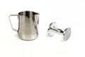 Milk steamer and coffee tamper on an isolated surface Royalty Free Stock Photo