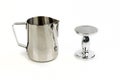 Milk steamer and coffee tamper standing on end on an isolated surface Royalty Free Stock Photo