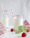 Milk with sugar sprinkles, strawberries and cupcake wrapper Royalty Free Stock Photo