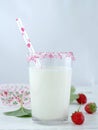 Milk with sugar sprinkles, strawberries and cupcake wrapper Royalty Free Stock Photo