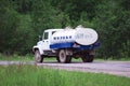 Milk tanker traveling on a rural road in the center of Russia