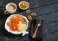 Milk tea, oranges, cheese and crackers on a white plate on a dark wooden surface Royalty Free Stock Photo