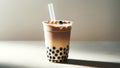 Milk tea with tapioca balls in a clear plastic cup