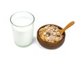 Milk in transparent glass and muesli multi fruit in wooden bowl and spoon isolated on white background ,include clipping path Royalty Free Stock Photo