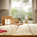 Milk on wooden kitchen tabletop and window with blurred outside garden background. Royalty Free Stock Photo