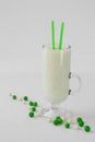 Milk yogurt smoothie cocktail green and white candy drop Royalty Free Stock Photo