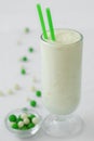 Milk yogurt smoothie cocktail white and green candy drop Royalty Free Stock Photo