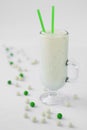 Milk yogurt smoothie cocktail white and green candy drop Royalty Free Stock Photo