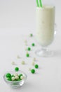 Milk yogurt smoothie cocktail white and green candy drop Royalty Free Stock Photo