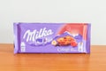 Milka alpine milk chocolate bar with collage with raspberry Royalty Free Stock Photo