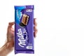 Milka Alpine Milk Chocolate. Studio shot, woman holding a Milka chocolate isolated on white background in Bucharest, Romania, 2019 Royalty Free Stock Photo