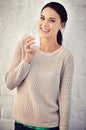 Milks great for the body. Portrait of a young woman drinking a glass of milk. Royalty Free Stock Photo