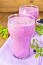 Milkshake with blueberries in glasses on board Royalty Free Stock Photo