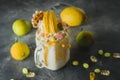 Milkshake with whipped cream, dripping sauce and yellow macaroon Royalty Free Stock Photo