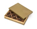 Milky and dark square chocolates in golden box, isolated